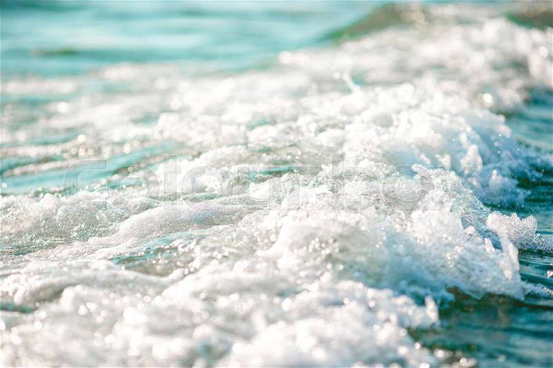 The shimmering sun shines on the sea floor. Wild wave on the sea, stock photo