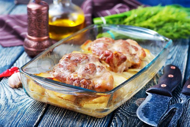 Baked meat with potato in glass plate, stock photo