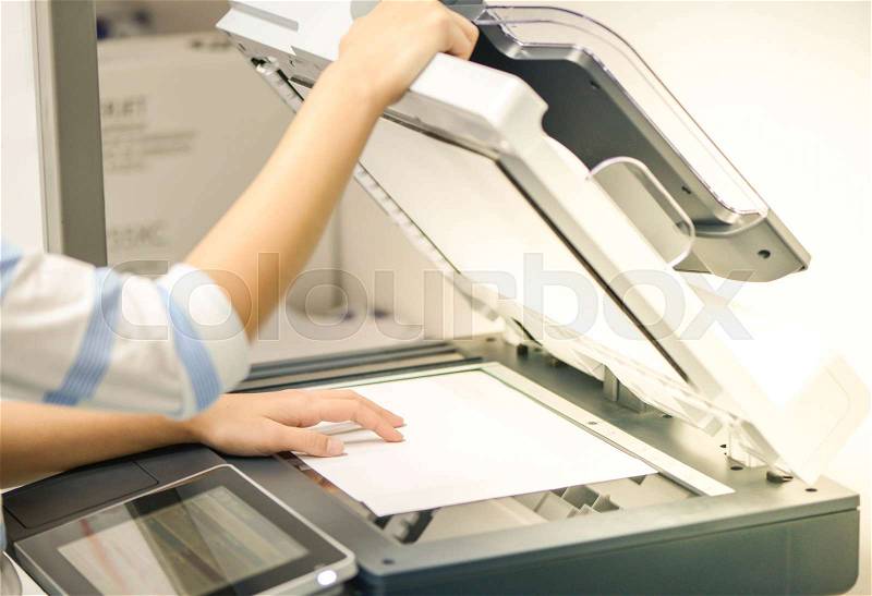 Business woman is using the printer to scanning the document, stock photo