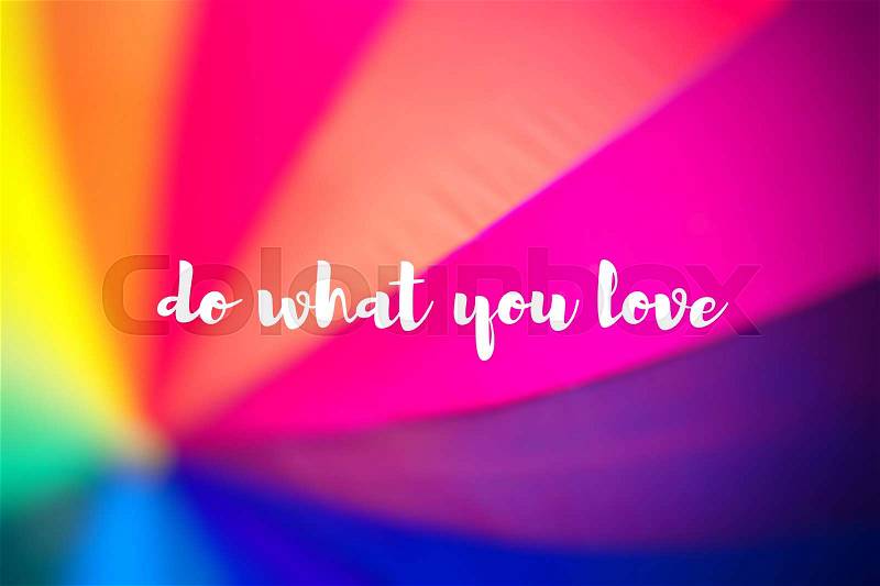 Do what you love. Rainbow coloured umbrella, stock photo