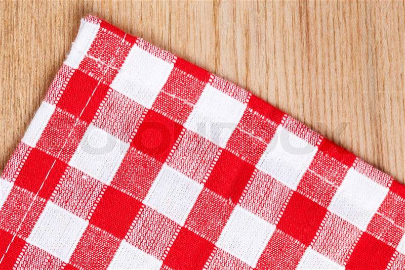 The checkered tablecloth on wooden table, stock photo