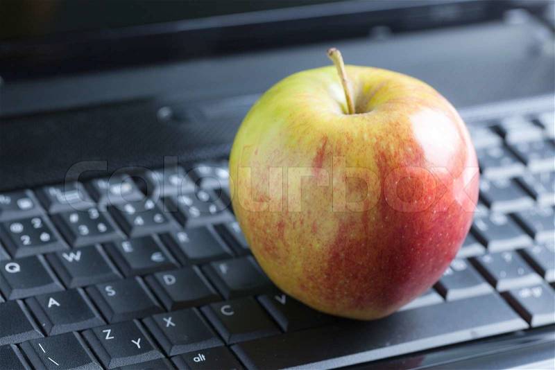 Photo shot of apple on laptop, stock photo