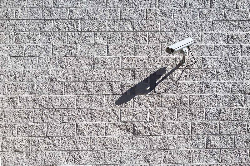 CCTV camera. Security camera on the tile wall. Private property protection, stock photo