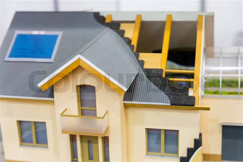 Model of house, thermal insulation of roof concept. Energy and money saving materials and systems, stock photo