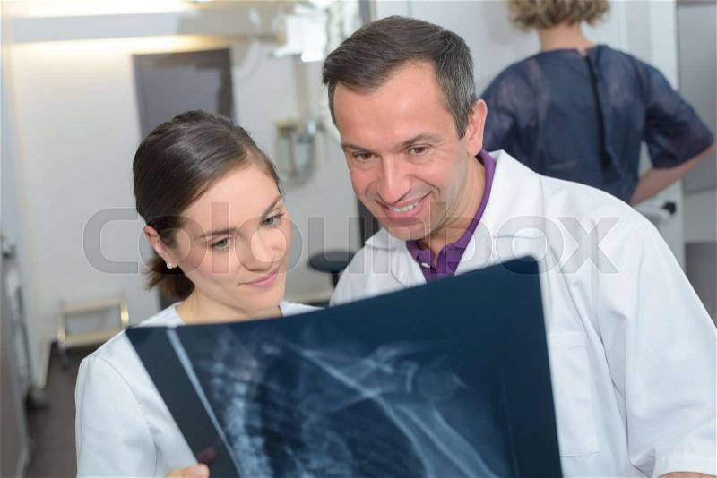 Medical and radiology concept - two doctors looking at x-ray, stock photo