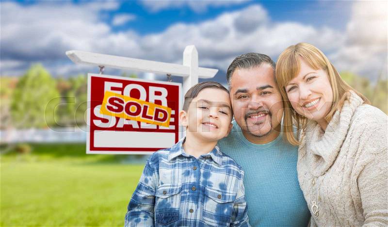 Mixed Race Family In Front of House and Sold For Sale Real Estate Sign, stock photo