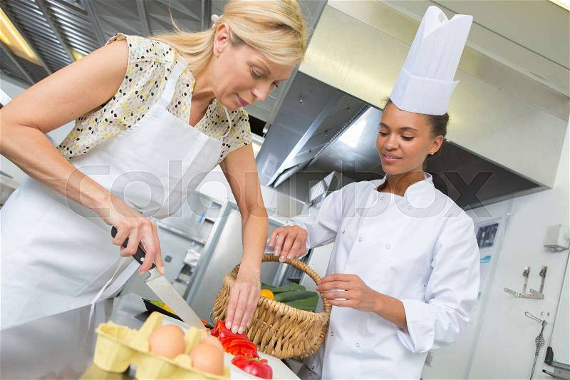 Cooking lesson with apprentice, stock photo