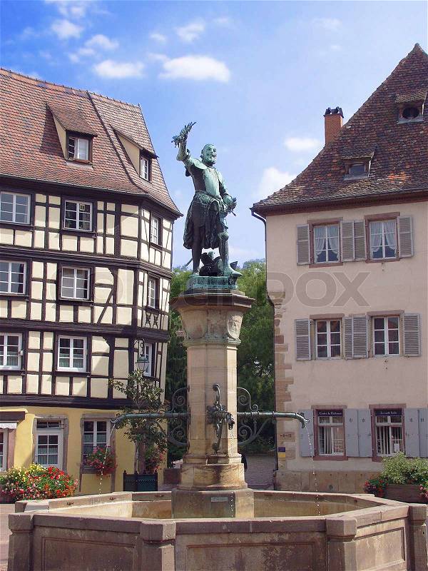 Statue and Fountain in central square of Colmar, France, stock photo
