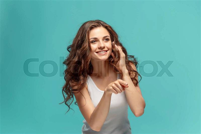 The young woman\'s portrait with happy emotions and mobile phone at studio, stock photo