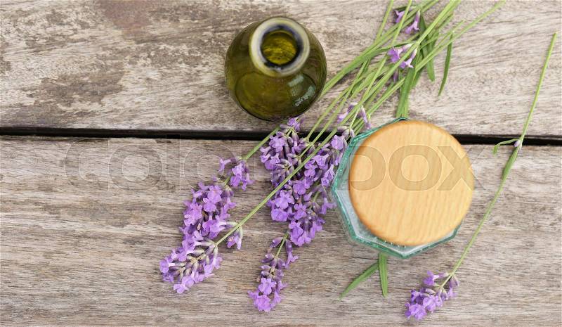 Fresh lavender and aroma oil essence in a bottle, stock photo