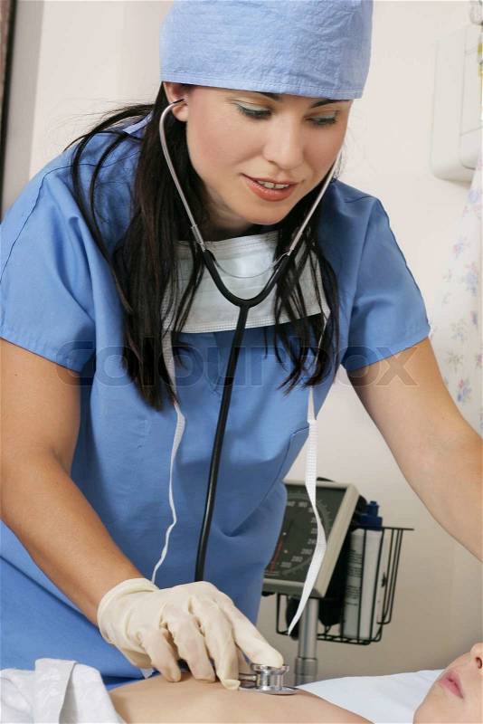 She is using her stethoscope, stock photo