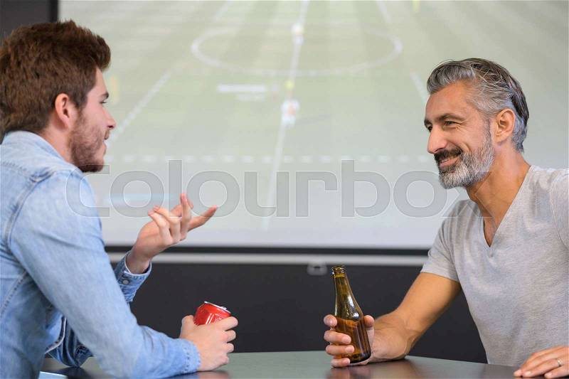 Friends are watching rugby match in a pub, stock photo