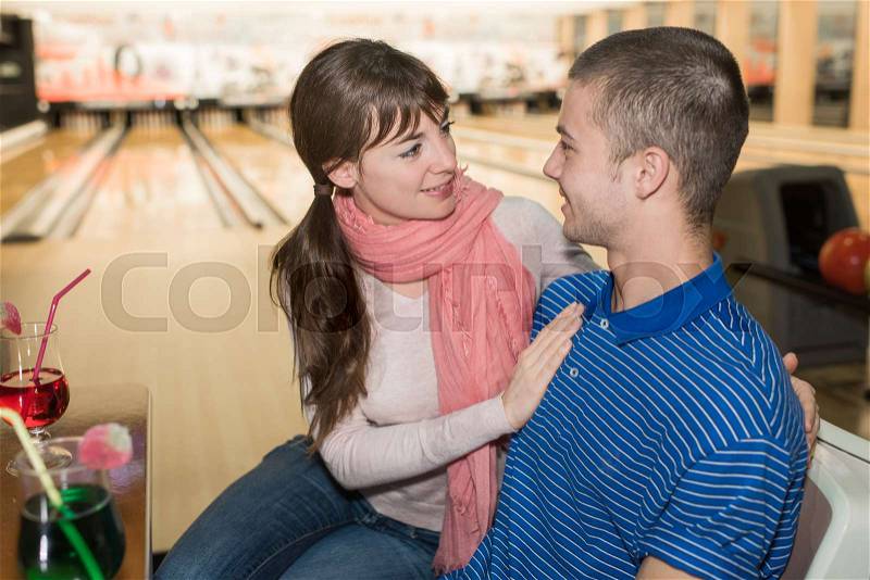 Dating couple enjoy bowling together, stock photo