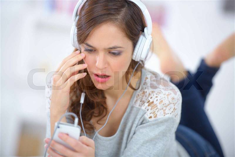 Unhappy pretty woman finding music files deleted, stock photo