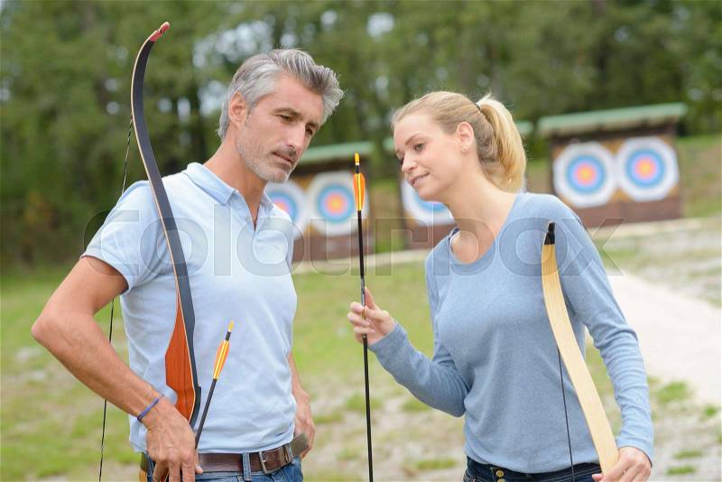 Archery couple practicing together, stock photo