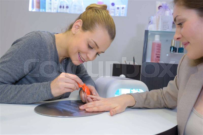 Woman getting her nails done at a beauty salon, stock photo