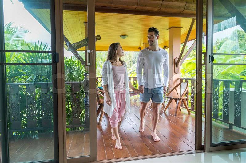 Young Couple On Terrace Tropical Hotel, Man And Woman Tropic Holiday Vacation Green Forest, stock photo