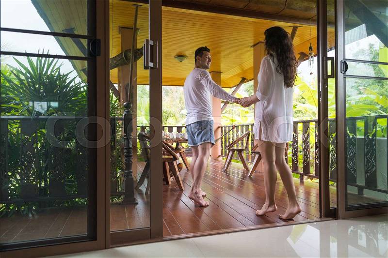 Young Couple On Terrace Tropical Hotel, Man And Woman Tropic Holiday Vacation Green Forest, stock photo