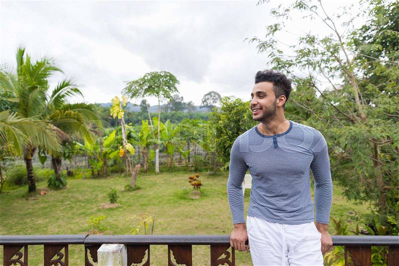 Happy Smiling Latin Man Over Green Tropical Rain Forest Landscape, Hispanic Guy Looking Aside, stock photo