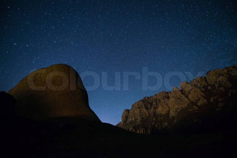 The starry sky above the mountains peaks, stock photo