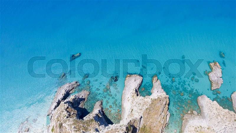 Overhead view of beautiful rocks over crystal clear ocean, stock photo