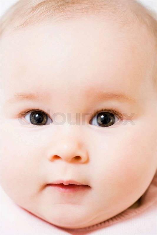 Baby looking to camera close-up, stock photo