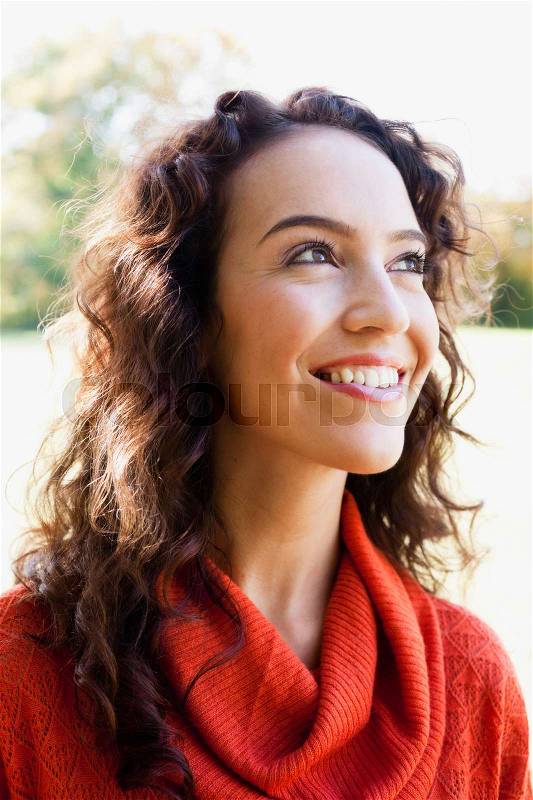 Young woman looking at the sky, stock photo