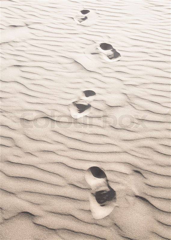 Footprints in sand, stock photo