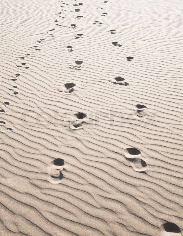 Footprints in sand, stock photo