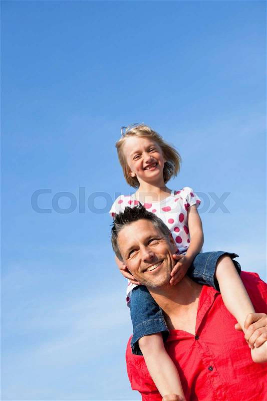 Girl Sitting On Fathers Shoulders, stock photo