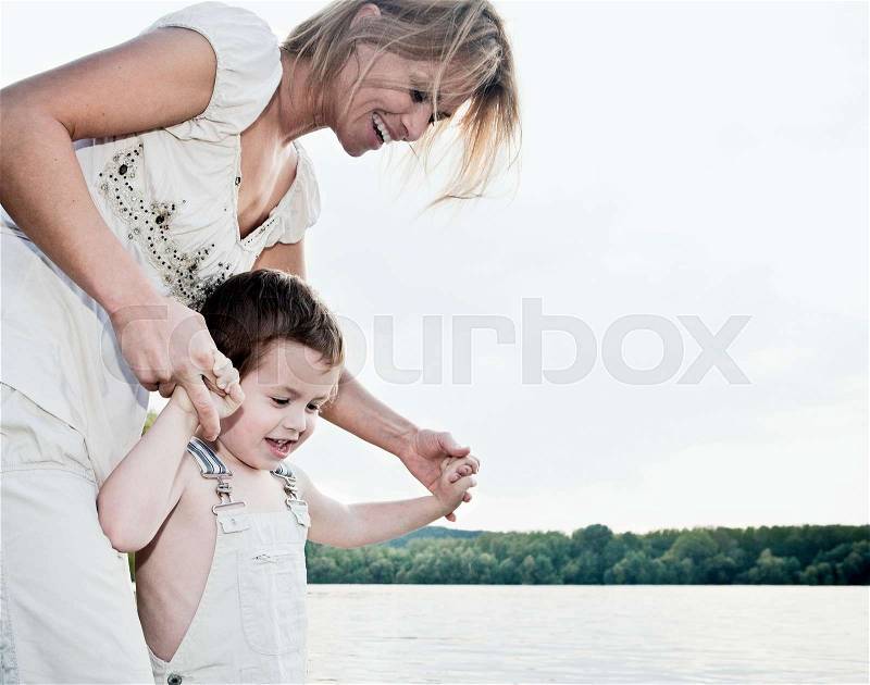 Mother helping child, stock photo