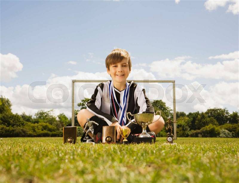 Boy footballer with Trophies, stock photo