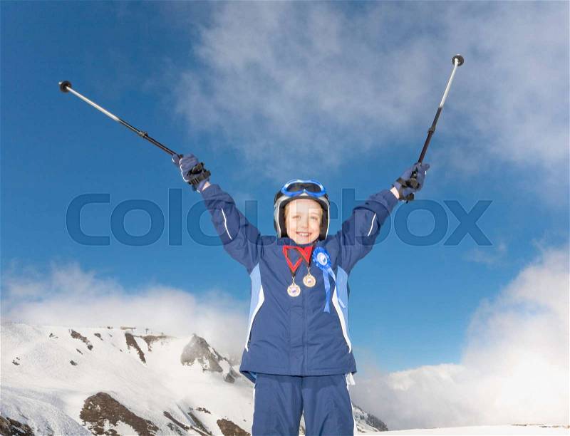 Boy wearing medals and with skis, stock photo