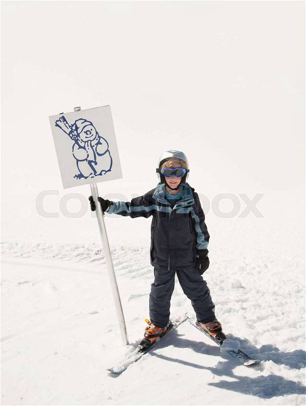 Boy skier holding snowman sign, stock photo