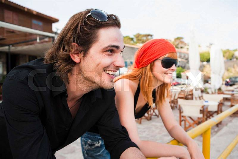 Couple leaning on rail, stock photo