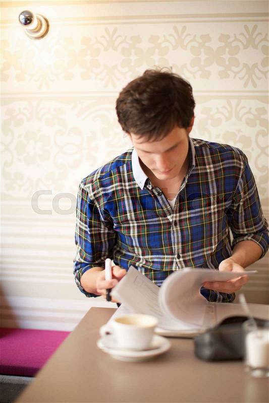 Student studying in a cafe, stock photo