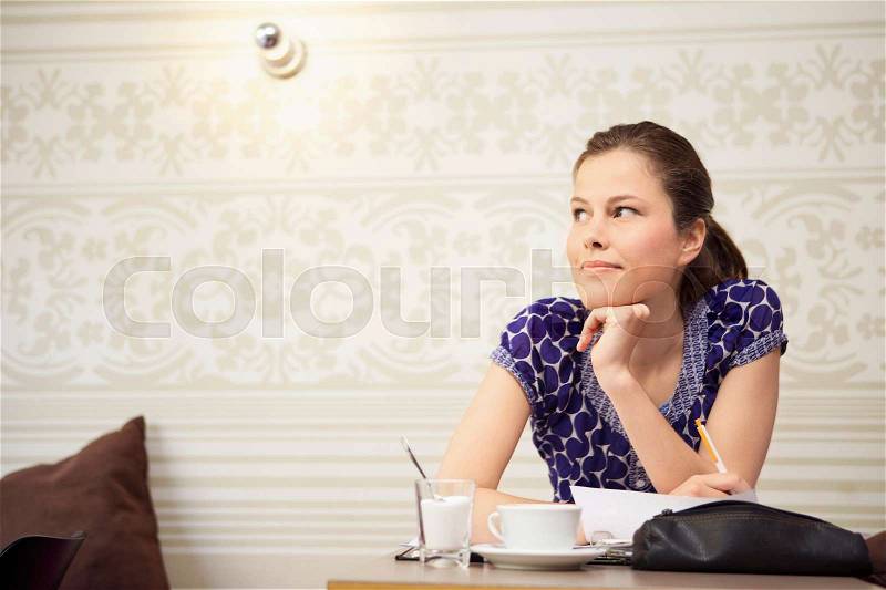 Student studying in a cafe, stock photo