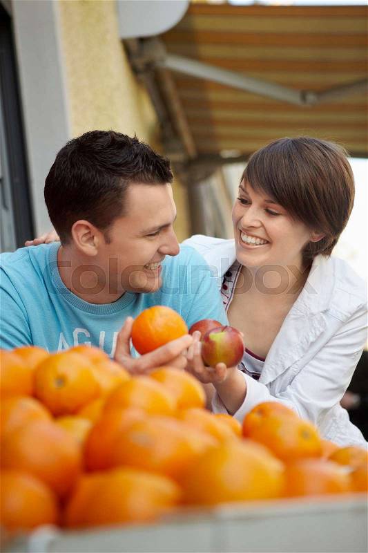 Young people buying fruits and vegetable, stock photo