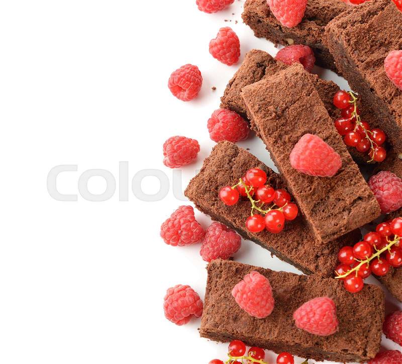 Chocolate brownies with raspberries and currants on a white background, stock photo