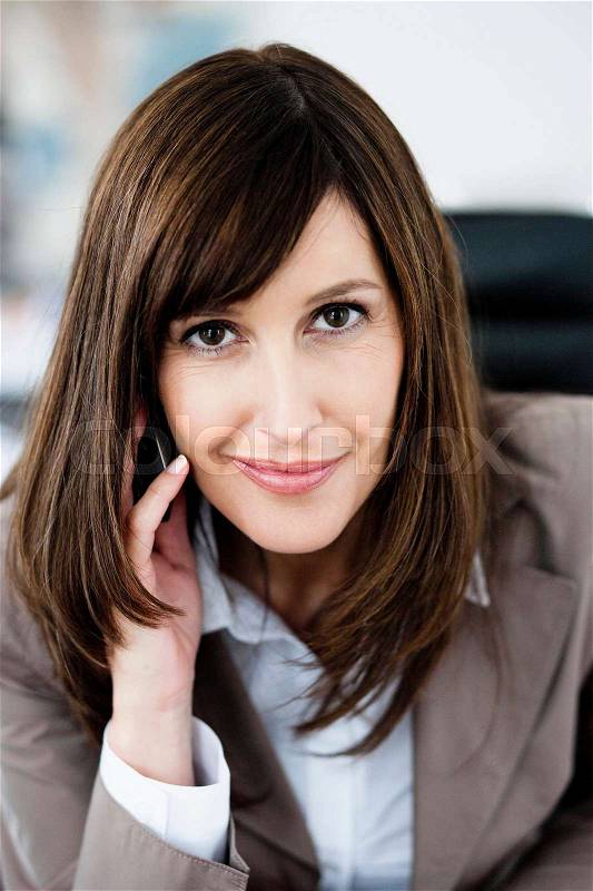 Woman in suit phoning, stock photo