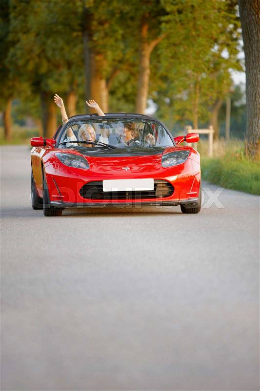 Couple in an electric sports car, fun, stock photo