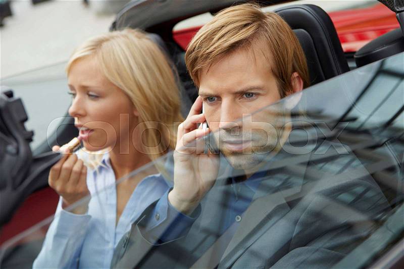 Couple in an electric sports car, stock photo