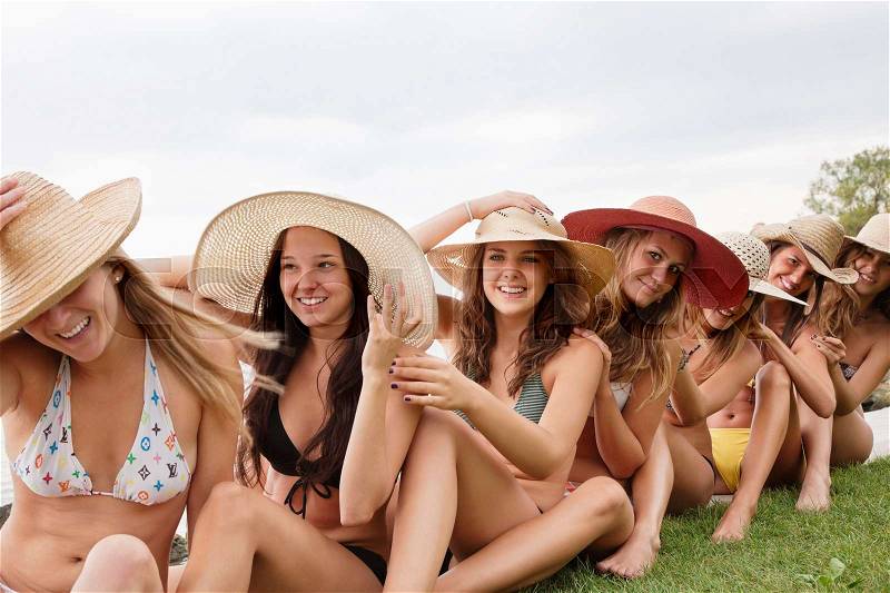 Women in bikinis make human chain, stock photo