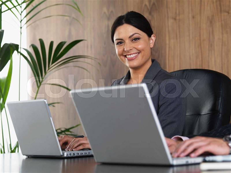 Business man and woman at desk, stock photo