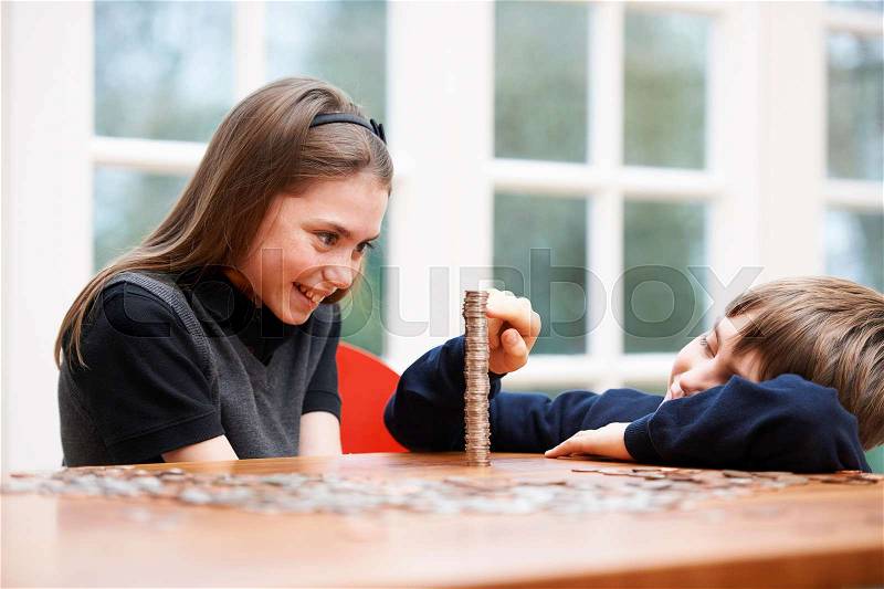 Children counting a pile of money, stock photo