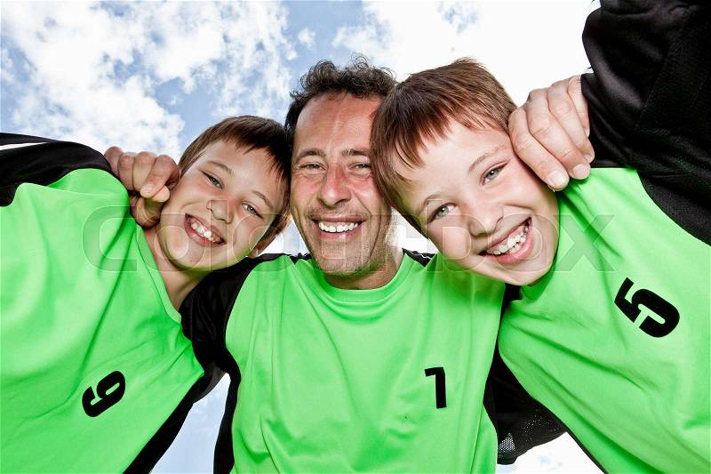 Father and sons team pep talk, stock photo