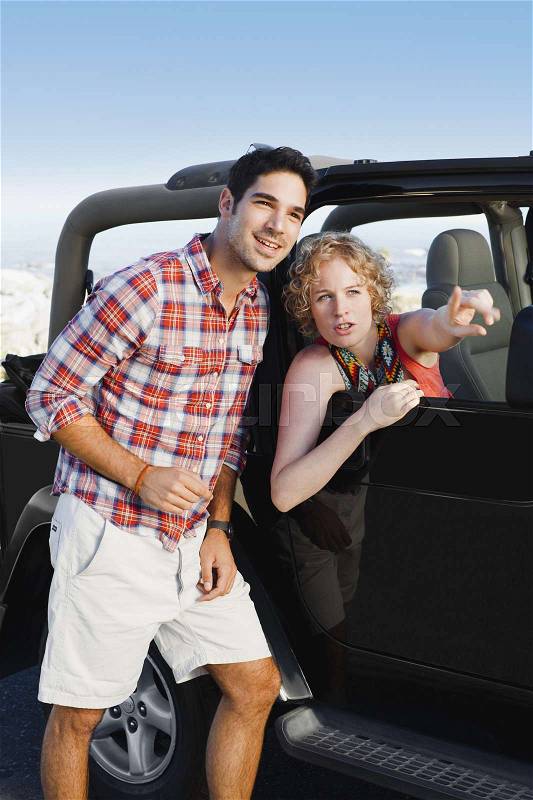 Woman in jeep giving man directions, stock photo
