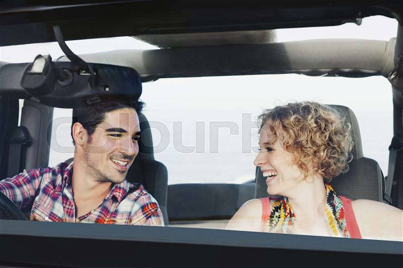 Couple riding in jeep together, stock photo