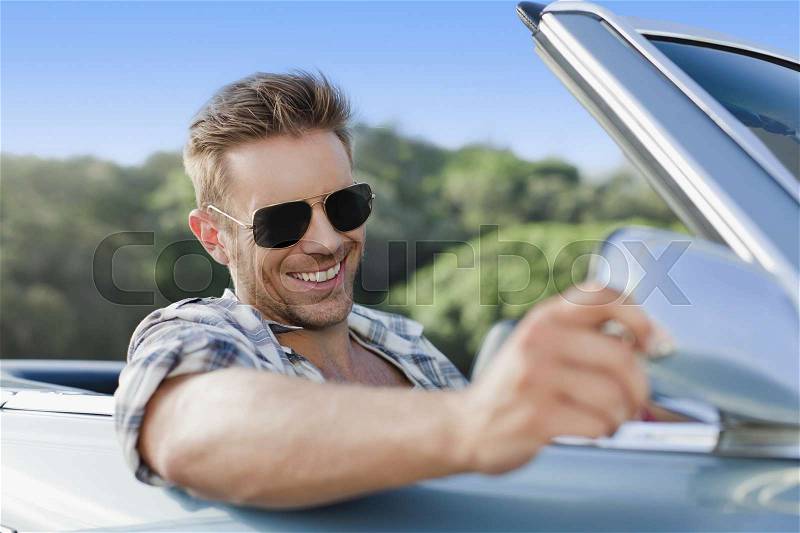 Man driving convertible, stock photo