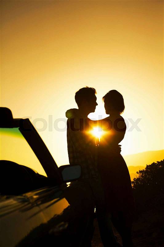 Silhouette of couple hugging, stock photo